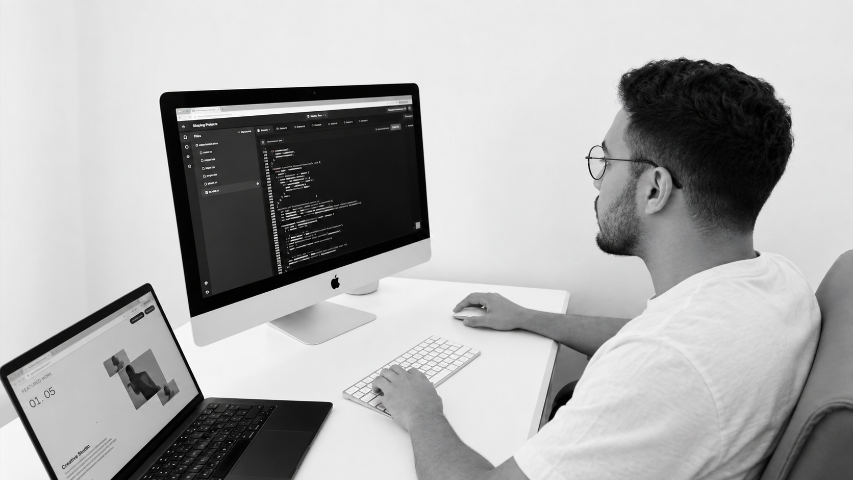 El Mehdi Fateh working at a desk with code on screen.